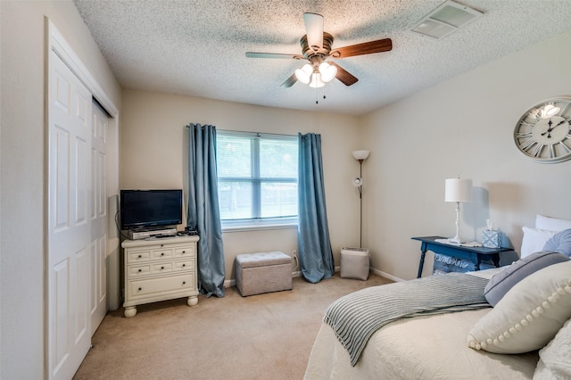 3601 Scranton Dr, Richland Hills, TX 76118 - bedroom with a closet, light colored carpet, a textured ceiling, and a ceiling fan