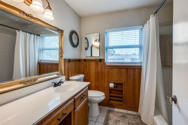 3601 Scranton Dr, Richland Hills, TX 76118 - full bath featuring toilet, vanity, a wainscoted wall, tile patterned flooring, and wood walls
