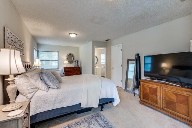 3601 Scranton Dr, Richland Hills, TX 76118 - bedroom featuring a textured ceiling, light colored carpet, and connected bathroom