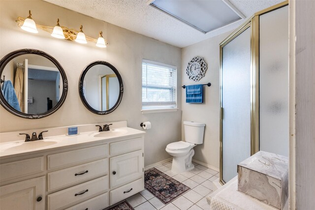 3601 Scranton Dr, Richland Hills, TX 76118 - full bathroom featuring double vanity, a shower stall, toilet, tile patterned flooring, and a textured ceiling