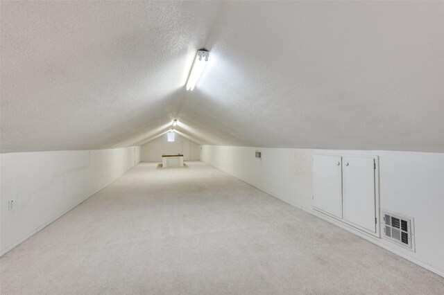 3601 Scranton Dr, Richland Hills, TX 76118 - bonus room with a textured ceiling, lofted ceiling, and light colored carpet