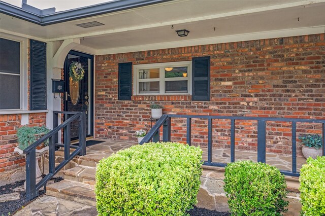 3601 Scranton Dr, Richland Hills, TX 76118 - view of exterior entry with brick siding and covered porch
