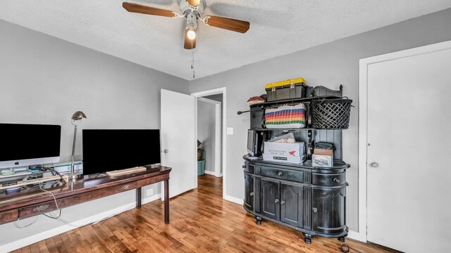 1007 SE 24th St, Mineral Wells, TX 76067 - office area featuring ceiling fan, a textured ceiling, wood finished floors, and baseboards