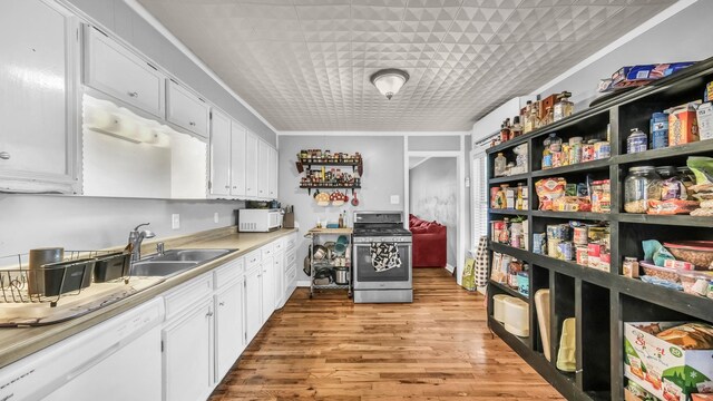 1007 SE 24th St, Mineral Wells, TX 76067 - kitchen with white appliances, a sink, white cabinets, and light wood-style floors