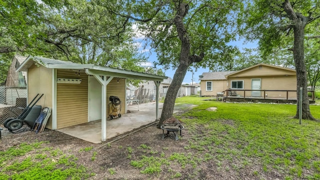 1007 SE 24th St, Mineral Wells, TX 76067 - view of yard featuring an outdoor fire pit, a carport, and a wooden deck