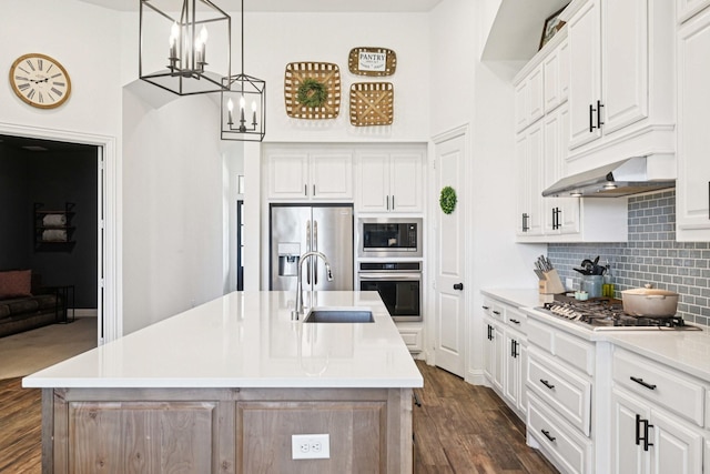 2816 Middleton Dr, Melissa, TX 75454 - kitchen featuring appliances with stainless steel finishes, a sink, a chandelier, backsplash, and dark wood finished floors