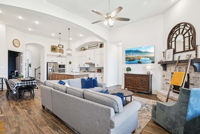 2816 Middleton Dr, Melissa, TX 75454 - living room with arched walkways, recessed lighting, ceiling fan, a high ceiling, and dark wood-style flooring