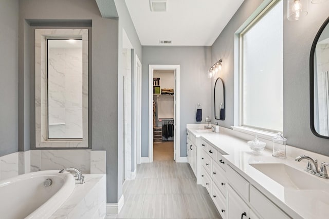 2816 Middleton Dr, Melissa, TX 75454 - full bath with double vanity, a garden tub, a spacious closet, and baseboards