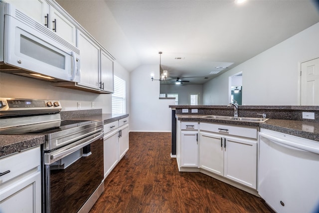 3901 Luck Hole Dr, Denton, TX 76210 - kitchen with white appliances, a sink, dark countertops, dark wood-style floors, and vaulted ceiling