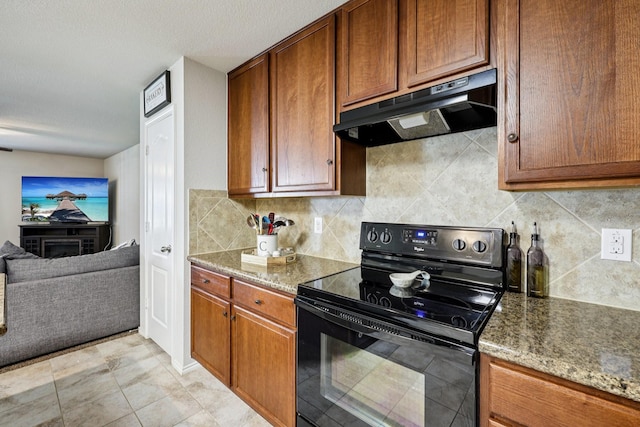 147 Cantle, Waxahachie, TX 75165 - kitchen featuring black electric range, under cabinet range hood, decorative backsplash, stone counters, and brown cabinetry