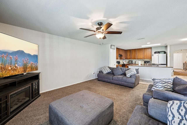 147 Cantle, Waxahachie, TX 75165 - living room with arched walkways, light colored carpet, a ceiling fan, and baseboards