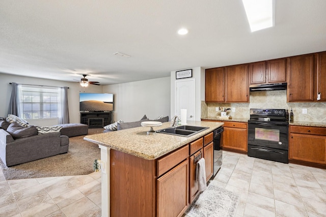 147 Cantle, Waxahachie, TX 75165 - kitchen featuring black appliances, under cabinet range hood, a sink, brown cabinets, and tasteful backsplash