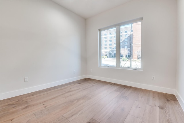 235 E Nash St Unit 124, Grapevine, TX 76051 - spare room with baseboards and light wood-type flooring