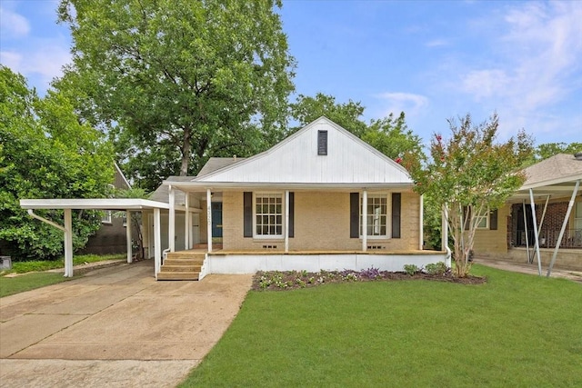 4320 Donnelly Ave, Fort Worth, TX 76107 - view of front of property featuring a porch, a front lawn, concrete driveway, brick siding, and an attached carport