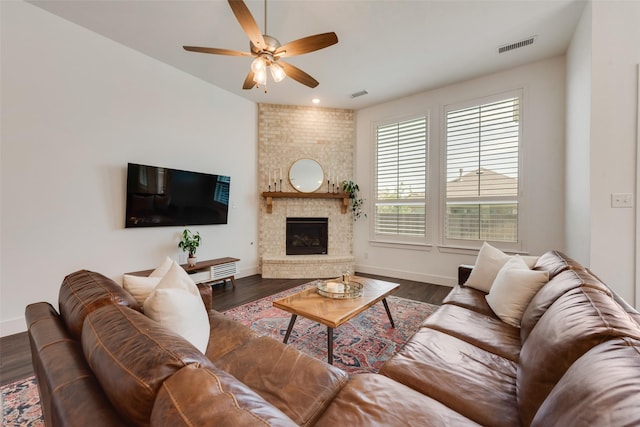 1124 Firecracker Dr, Justin, TX 76247 - living area featuring a ceiling fan, baseboards, a brick fireplace, and dark wood-style floors