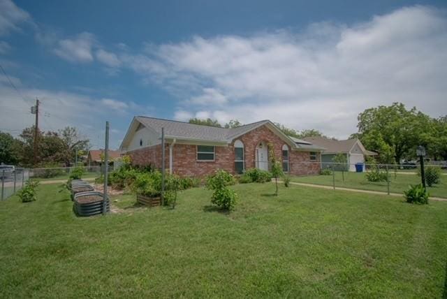 301 Patricia St, Lacy Lakeview, TX 76705 - view of front of house with a vegetable garden and brick siding