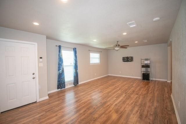 301 Patricia St, Lacy Lakeview, TX 76705 - unfurnished living room with wood finished floors, ceiling fan, recessed lighting, and baseboards