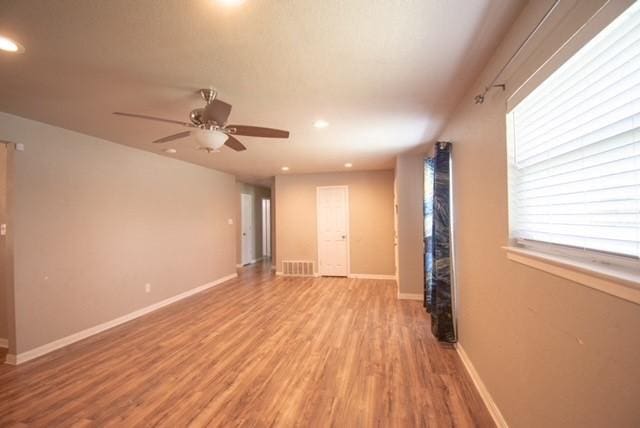 301 Patricia St, Lacy Lakeview, TX 76705 - unfurnished room featuring light wood-style flooring, ceiling fan, recessed lighting, and baseboards