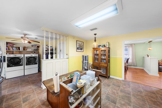 808 S Main St, Winnsboro, TX 75494 - dining space with separate washer and dryer, stone finish floors, ceiling fan, and baseboards