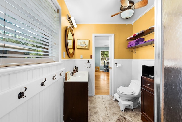 808 S Main St, Winnsboro, TX 75494 - bathroom featuring vanity, a wainscoted wall, toilet, tile patterned floors, and ceiling fan