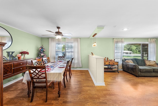 808 S Main St, Winnsboro, TX 75494 - dining space with healthy amount of natural light, wood finished floors, ceiling fan, and crown molding