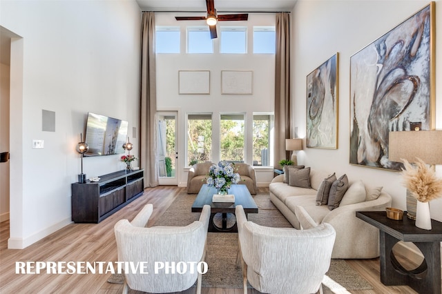 2233 Lakelet Dr, Mckinney, TX 75071 - living area with a high ceiling, wood finished floors, a ceiling fan, and baseboards