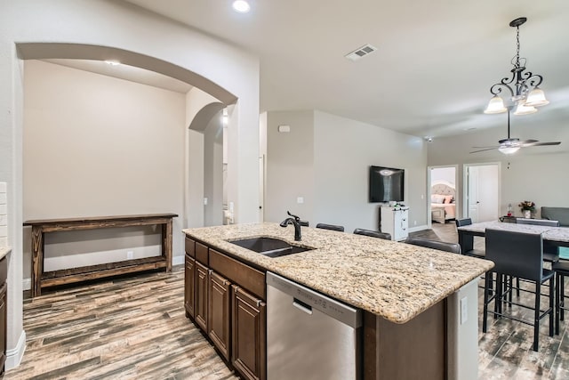 11741 Buckthorn Dr, Fort Worth, TX 76108 - kitchen with stainless steel dishwasher, a sink, ceiling fan, arched walkways, and wood finished floors