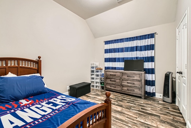 11741 Buckthorn Dr, Fort Worth, TX 76108 - bedroom featuring wood finished floors, lofted ceiling, heating unit, and baseboards