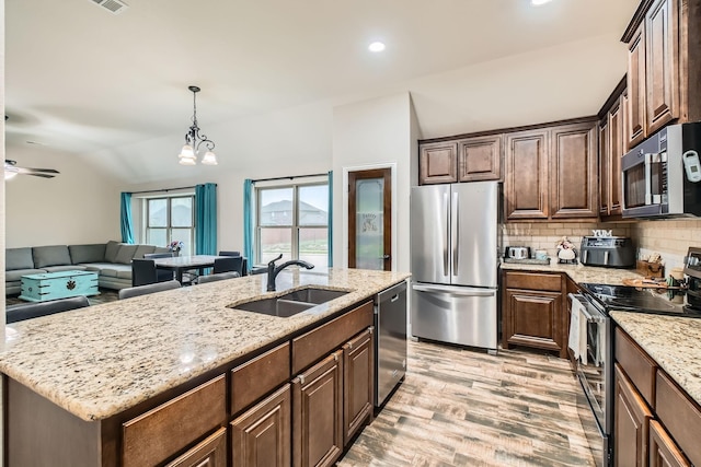 11741 Buckthorn Dr, Fort Worth, TX 76108 - kitchen with appliances with stainless steel finishes, a sink, light wood-style flooring, decorative backsplash, and light stone counters