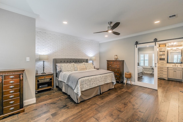 200 Sabine Creek Rd, Royse City, TX 75189 - bedroom with a barn door, brick wall, dark wood-type flooring, crown molding, and baseboards