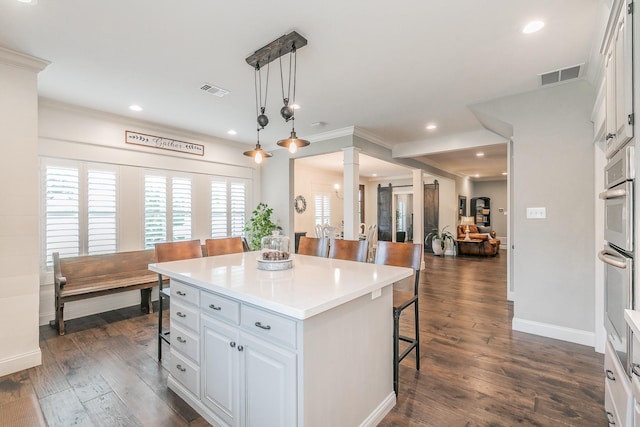 200 Sabine Creek Rd, Royse City, TX 75189 - kitchen featuring decorative columns, a kitchen breakfast bar, a kitchen island, plenty of natural light, and crown molding
