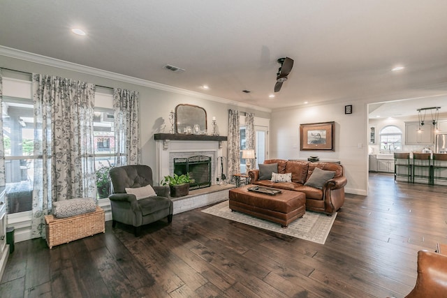200 Sabine Creek Rd, Royse City, TX 75189 - living area with ceiling fan, a fireplace with raised hearth, dark wood-style flooring, ornamental molding, and recessed lighting