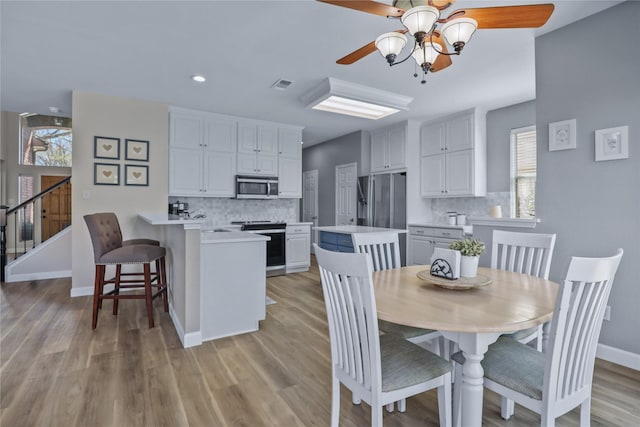 2904 Coventry Ln, Mckinney, TX 75069 - dining area with a ceiling fan, plenty of natural light, light wood-type flooring, baseboards, and recessed lighting