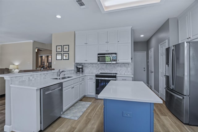 2904 Coventry Ln, Mckinney, TX 75069 - kitchen featuring stainless steel appliances, a sink, a peninsula, light wood finished floors, and light countertops