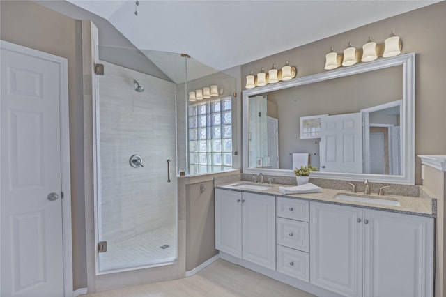 2904 Coventry Ln, Mckinney, TX 75069 - bathroom featuring double vanity, a shower stall, vaulted ceiling, and tile patterned floors