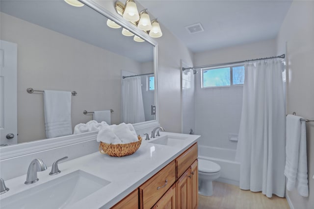 2904 Coventry Ln, Mckinney, TX 75069 - full bath featuring toilet, double vanity, shower / bath combo with shower curtain, and wood finished floors