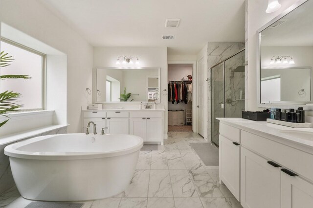 2414 Seth Dr, Midlothian, TX 76065 - bathroom with marble finish flooring, a shower stall, two vanities, a freestanding bath, and a spacious closet