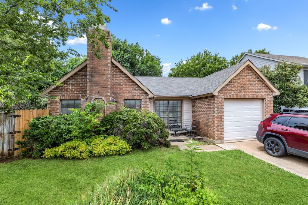12 Brewster Ct, Allen, TX 75002 - view of front of home featuring brick siding, a chimney, an attached garage, and concrete driveway