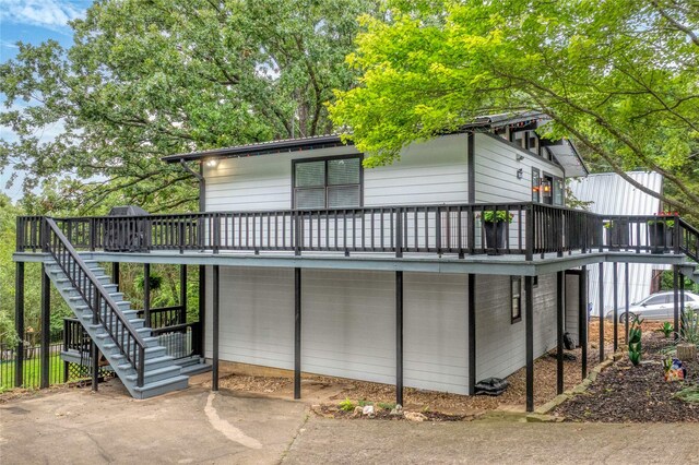 207 Wales Dr, Pottsboro, TX 75076 - view of front of home featuring stairway, a wooden deck, and a patio