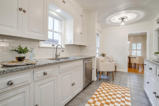 3201 Lamesa Pl, Fort Worth, TX 76109 - kitchen featuring a sink, stainless steel dishwasher, ornamental molding, light tile patterned flooring, and tasteful backsplash