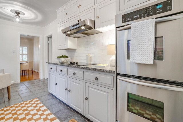 3201 Lamesa Pl, Fort Worth, TX 76109 - kitchen featuring double oven, exhaust hood, black electric stovetop, decorative backsplash, and white cabinets