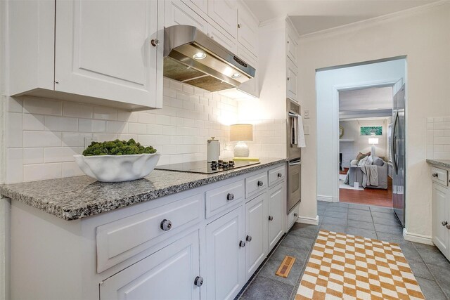 3201 Lamesa Pl, Fort Worth, TX 76109 - kitchen with under cabinet range hood, appliances with stainless steel finishes, white cabinetry, tile patterned floors, and ornamental molding