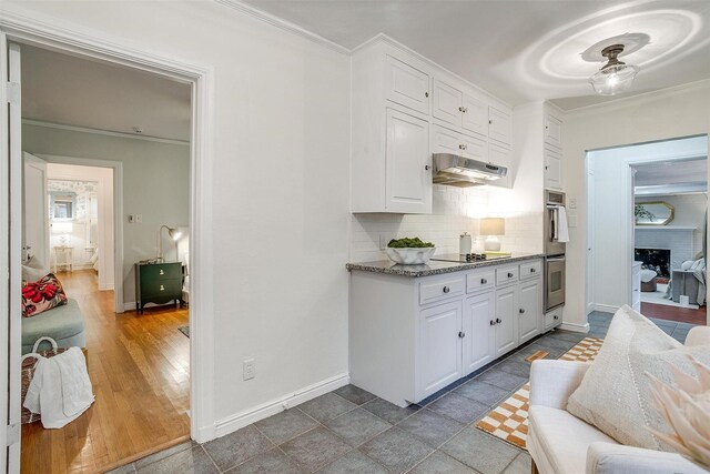 3201 Lamesa Pl, Fort Worth, TX 76109 - kitchen with ventilation hood, white cabinetry, tasteful backsplash, ornamental molding, and black electric stovetop