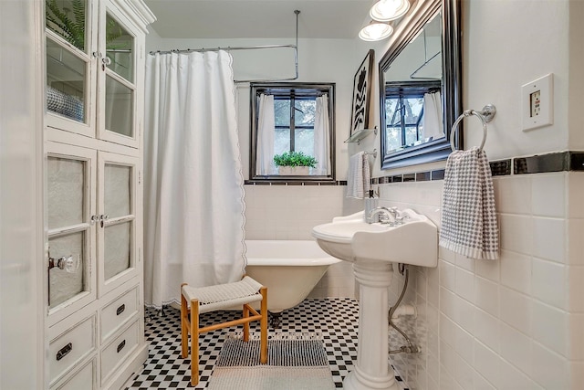 3201 Lamesa Pl, Fort Worth, TX 76109 - full bath with a freestanding tub, tile walls, a wainscoted wall, tile patterned floors, and curtained shower