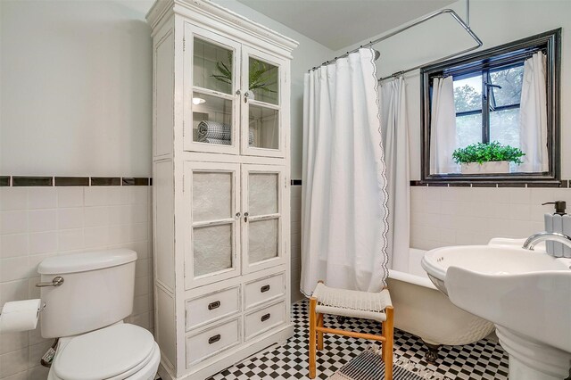 3201 Lamesa Pl, Fort Worth, TX 76109 - full bath featuring tile walls, toilet, shower / bath combo with shower curtain, wainscoting, and a sink