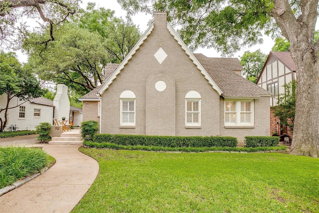 3201 Lamesa Pl, Fort Worth, TX 76109 - view of front of home featuring roof with shingles, brick siding, a front lawn, and a chimney