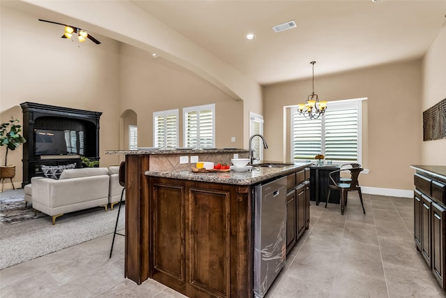 4312 Oxbow Dr, Mckinney, TX 75072 - kitchen featuring a sink, dishwasher, a kitchen breakfast bar, dark brown cabinetry, and healthy amount of natural light