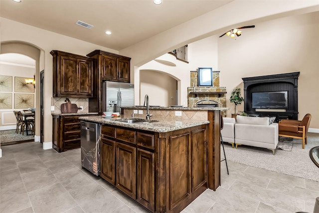 4312 Oxbow Dr, Mckinney, TX 75072 - kitchen with stainless steel appliances, a sink, a kitchen breakfast bar, open floor plan, and backsplash