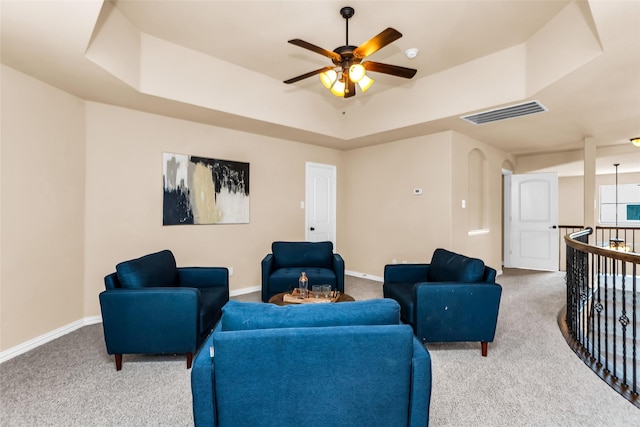4312 Oxbow Dr, Mckinney, TX 75072 - carpeted living area featuring a tray ceiling, ceiling fan, and baseboards