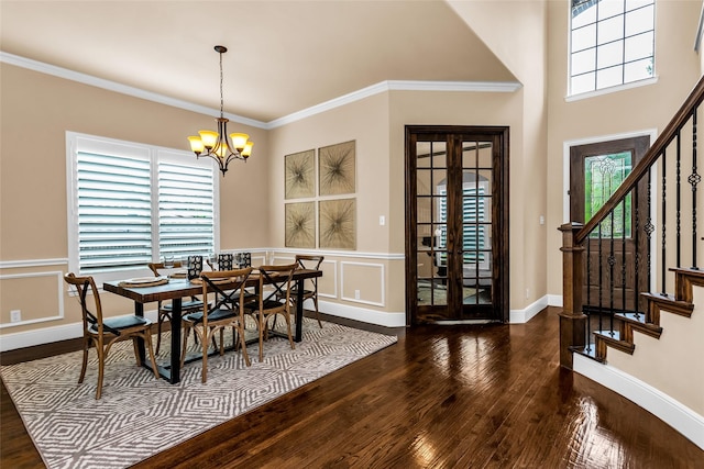 4312 Oxbow Dr, Mckinney, TX 75072 - dining space with hardwood / wood-style flooring, stairway, healthy amount of natural light, a chandelier, and a decorative wall